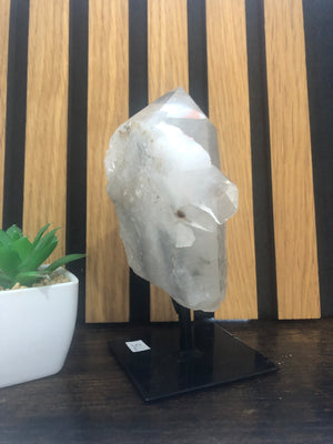 Raw-polished clear Quartz on stand